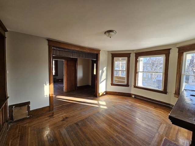 unfurnished room with dark wood-type flooring