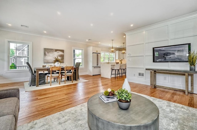 46 Pearl St, Melrose, MA 02176 - living room featuring crown molding, light wood-type flooring, and recessed lighting