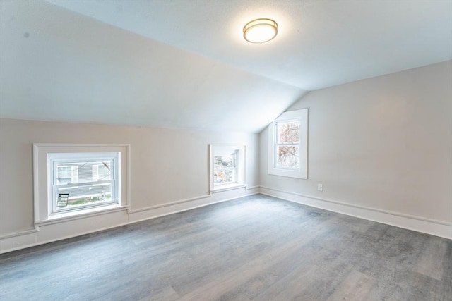 bonus room featuring lofted ceiling, baseboards, and wood finished floors
