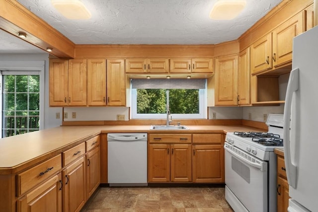 399 Pond St Unit G6, Braintree, MA 02184 - kitchen featuring white appliances, a peninsula, light countertops, a textured ceiling, and stone finish flooring