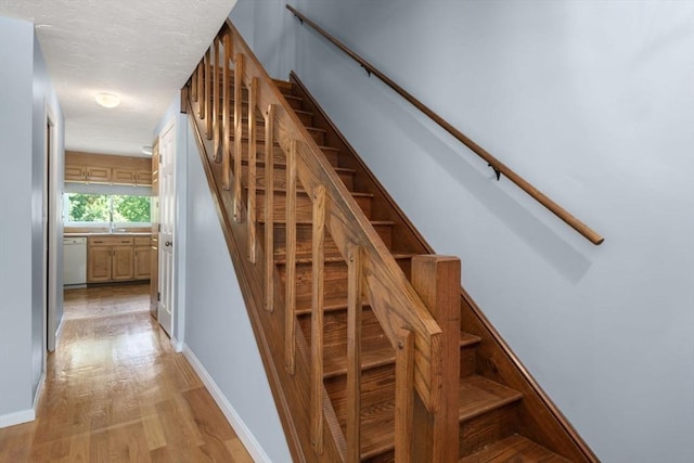 399 Pond St Unit G6, Braintree, MA 02184 - stairway with wood finished floors and baseboards