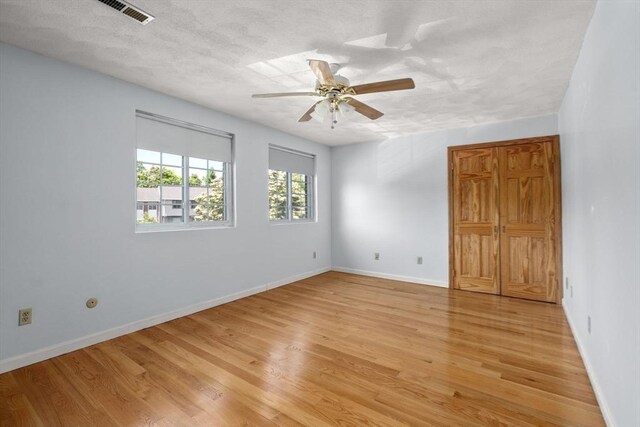 399 Pond St Unit G6, Braintree, MA 02184 - unfurnished room with light wood-type flooring, ceiling fan, and a textured ceiling