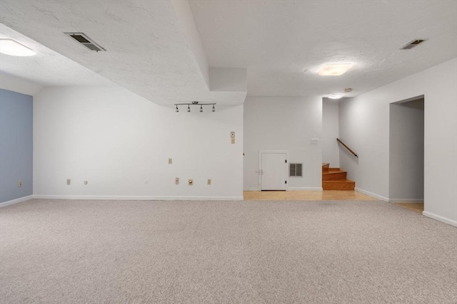 399 Pond St Unit G6, Braintree, MA 02184 - unfurnished room with light carpet, stairs, and a textured ceiling