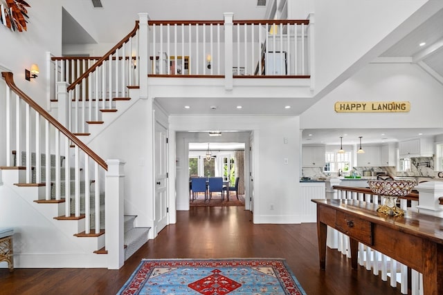 entryway featuring a high ceiling and dark hardwood / wood-style floors