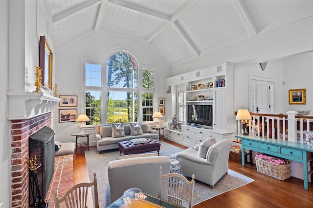 living room featuring wood ceiling, dark wood-type flooring, high vaulted ceiling, a fireplace, and beam ceiling