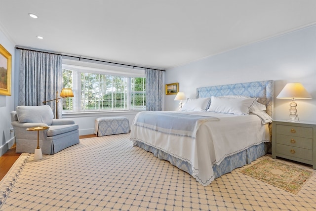 bedroom featuring crown molding and hardwood / wood-style flooring