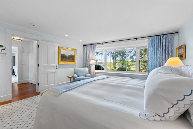 bedroom featuring hardwood / wood-style floors and crown molding