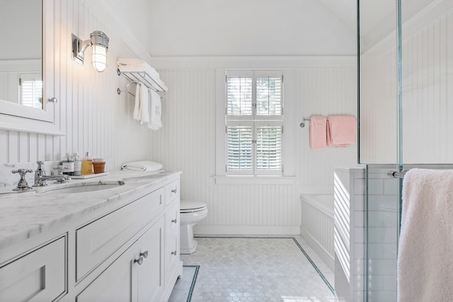 bathroom featuring vanity, a bathtub, tile patterned flooring, and toilet