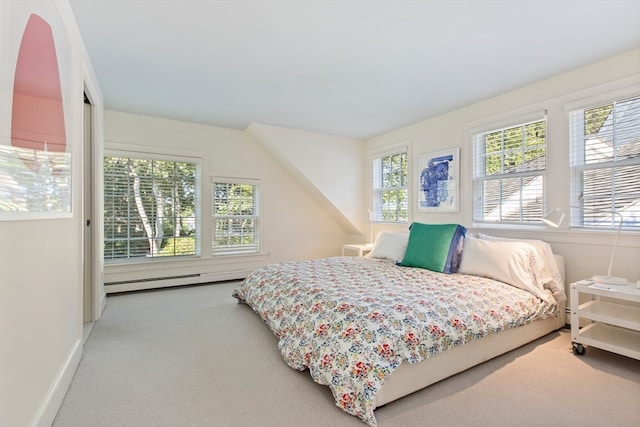 carpeted bedroom with a baseboard heating unit