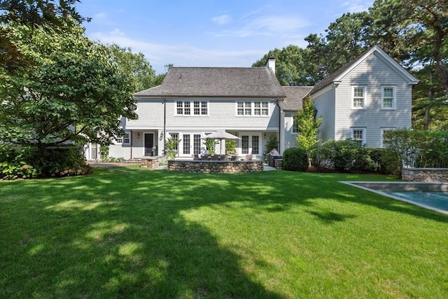 back of house with a lawn