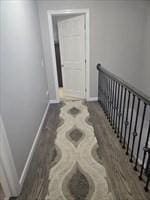 corridor with baseboards and stairs