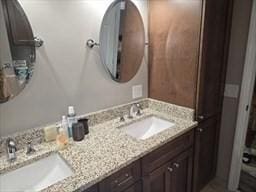 bathroom featuring a sink and double vanity