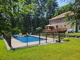 view of swimming pool featuring a fenced in pool, fence, and a lawn