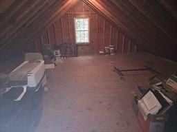 unfinished attic with an AC wall unit