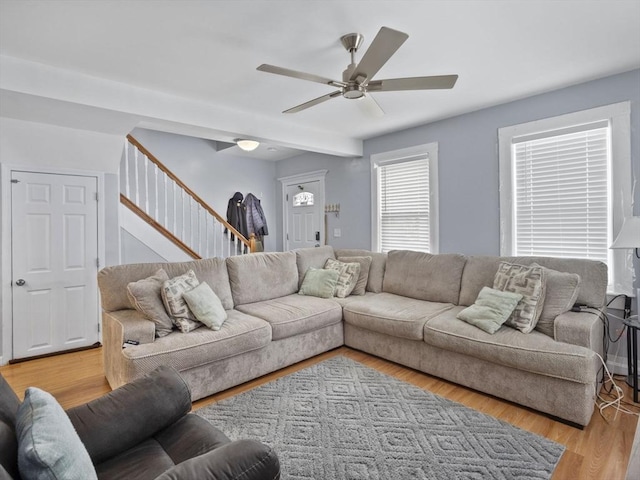 living room featuring light wood-type flooring and ceiling fan