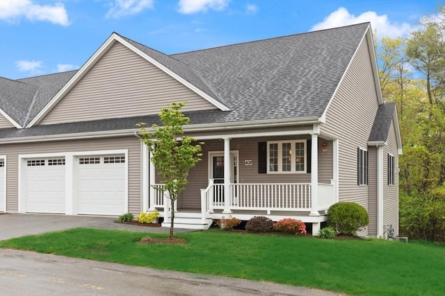view of front of house featuring a garage, a porch, a shingled roof, driveway, and a front yard