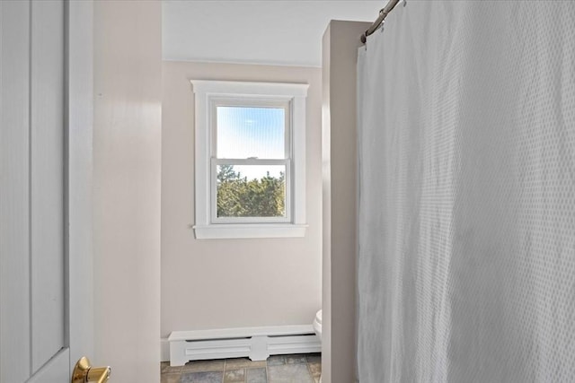 bathroom with a baseboard radiator and toilet