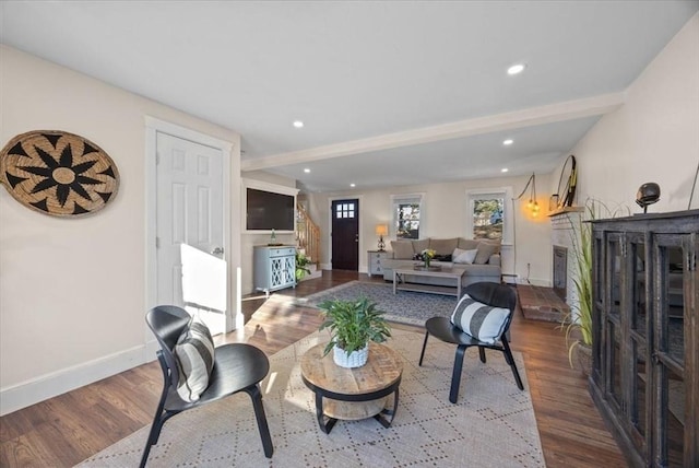 living room with hardwood / wood-style flooring and beam ceiling