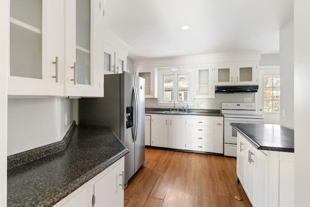 kitchen featuring sink, white cabinetry, plenty of natural light, and electric stove