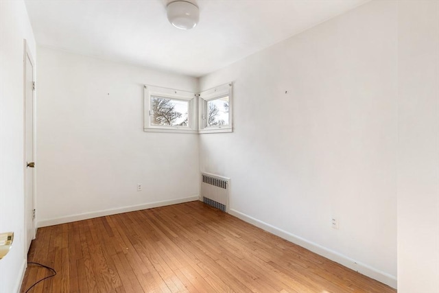 empty room featuring light hardwood / wood-style floors and radiator