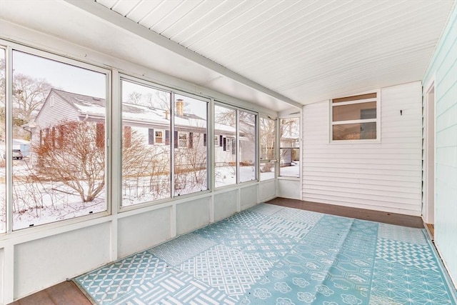 unfurnished sunroom featuring lofted ceiling