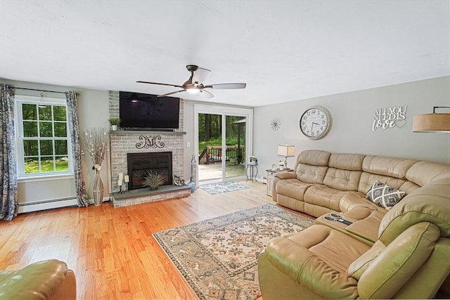 14 Daniels Rd, Charlton, MA 01507 - living room with a ceiling fan, wood finished floors, a brick fireplace, and a baseboard heating unit