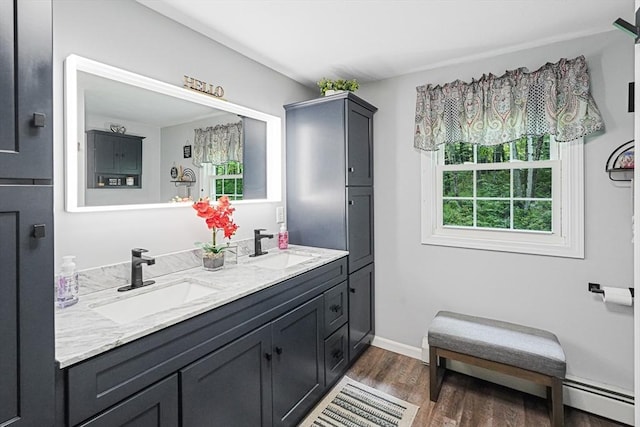 14 Daniels Rd, Charlton, MA 01507 - full bath with a baseboard radiator, double vanity, wood finished floors, and baseboards