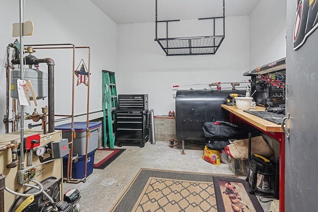 14 Daniels Rd, Charlton, MA 01507 - garage with oil tank, a heating unit, and a workshop area