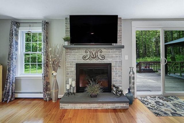 14 Daniels Rd, Charlton, MA 01507 - detailed view of wood finished floors, a fireplace, and a baseboard radiator
