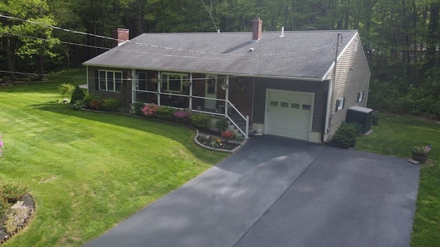 14 Daniels Rd, Charlton, MA 01507 - view of front of house featuring a chimney, a garage, and a front lawn