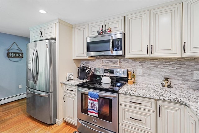 14 Daniels Rd, Charlton, MA 01507 - kitchen with stainless steel appliances, baseboard heating, backsplash, light wood-type flooring, and recessed lighting