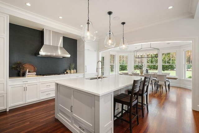 210 Monument Farm Rd, Concord, MA 01742 - kitchen featuring light countertops, wall chimney exhaust hood, dark wood-style flooring, and a sink