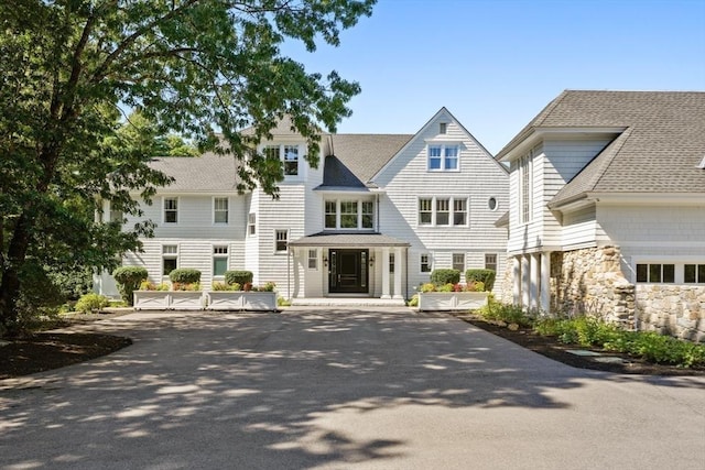 210 Monument Farm Rd, Concord, MA 01742 - exterior space featuring stone siding and roof with shingles