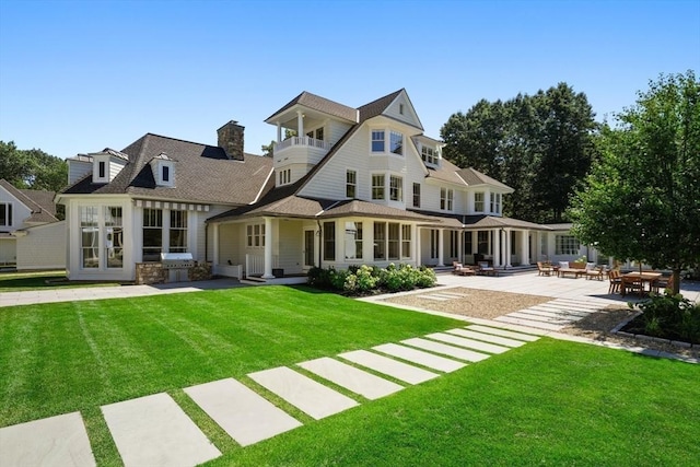 210 Monument Farm Rd, Concord, MA 01742 - rear view of property featuring a yard, a patio, a chimney, and a balcony