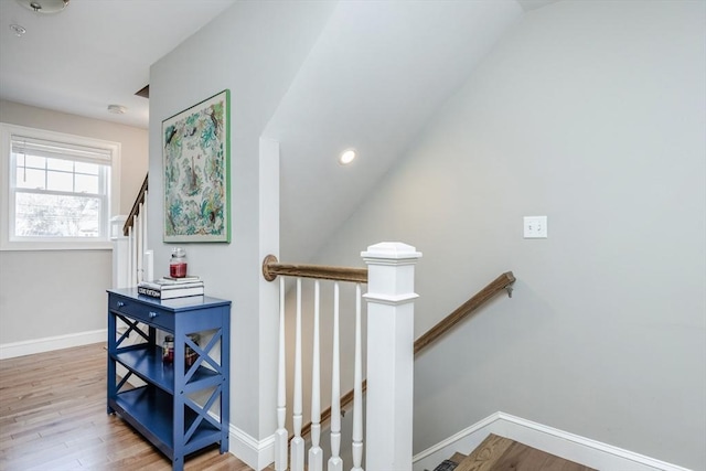 stairway with baseboards and wood finished floors