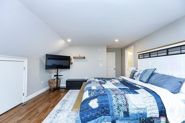 bedroom with visible vents, baseboards, lofted ceiling, recessed lighting, and wood finished floors