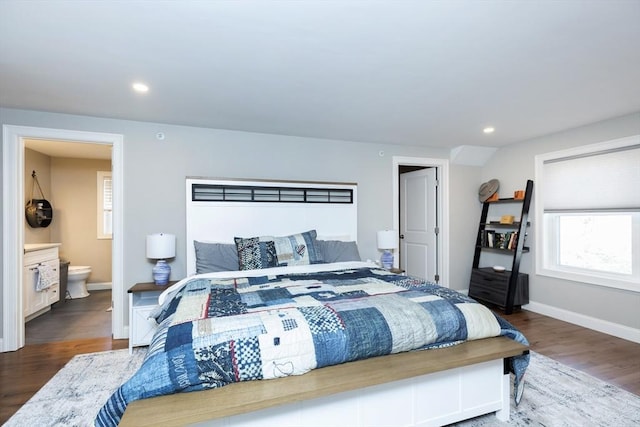 bedroom featuring recessed lighting, baseboards, wood finished floors, and ensuite bathroom