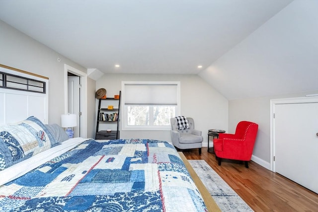 bedroom with vaulted ceiling, recessed lighting, wood finished floors, and baseboards