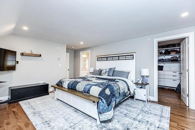 bedroom featuring a spacious closet, recessed lighting, and wood finished floors