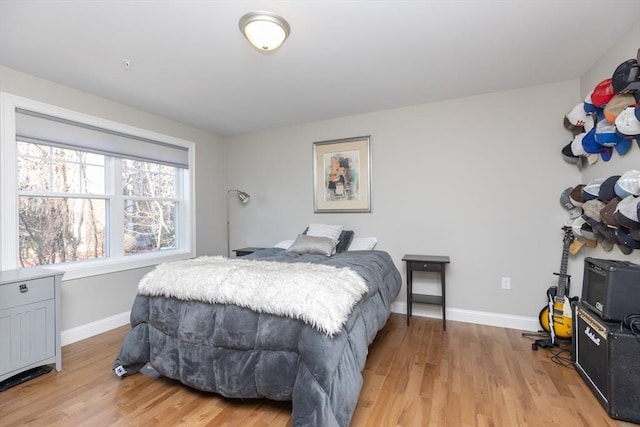 bedroom featuring light wood-style flooring and baseboards