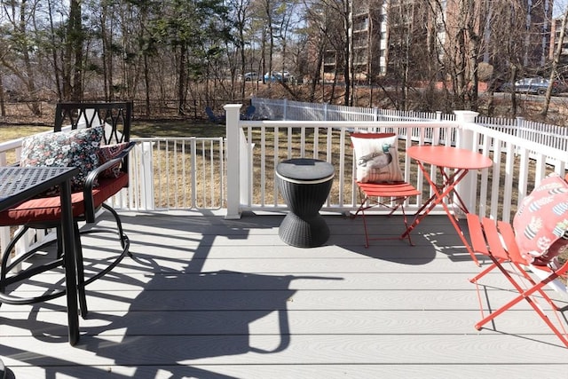 wooden terrace featuring outdoor dining space and fence