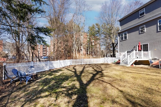 view of yard with a wooden deck and a fenced backyard