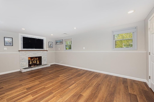 27 Ann St, Raynham, MA 02767 - unfurnished living room with a warm lit fireplace, wood finished floors, and recessed lighting