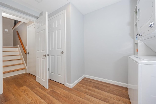 27 Ann St, Raynham, MA 02767 - washroom with stacked washer and clothes dryer and light wood-type flooring