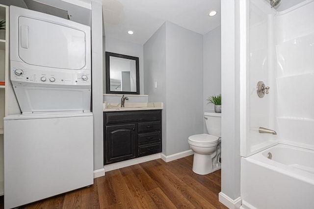 27 Ann St, Raynham, MA 02767 - bathroom featuring estacked washer and dryer, vanity, wood finished floors, tub / shower combination, and recessed lighting