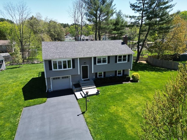 27 Ann St, Raynham, MA 02767 - raised ranch with driveway, a garage, roof with shingles, and a chimney