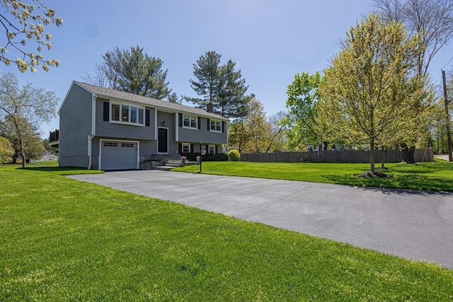 27 Ann St, Raynham, MA 02767 - bi-level home with driveway and an attached garage