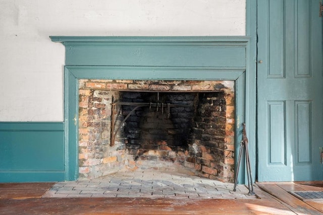 details with a brick fireplace and visible vents