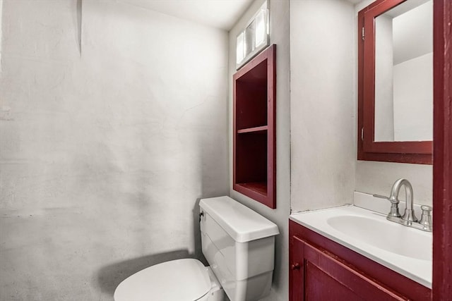 bathroom featuring toilet and vanity