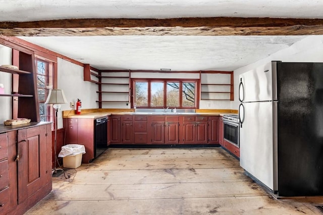 kitchen with stainless steel appliances, a sink, light countertops, light wood-type flooring, and open shelves